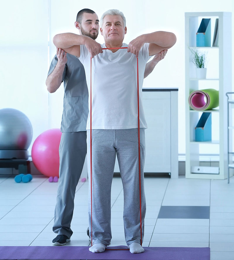 Physiotherapist working with patient in clinic